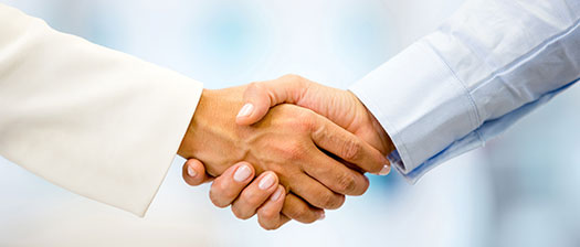 people in pale jackets shake hands