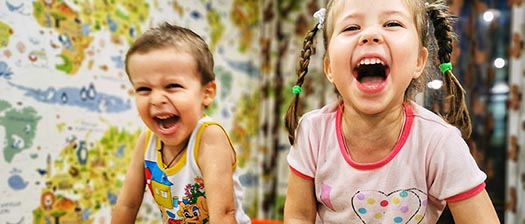 two children laughing and playing 