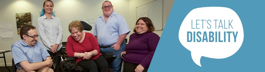 Five people are in a room. Two are standing in the back, and three are using wheelchairs. They are all smiling and laughing. To the right is a blue background with white text that says Let's Talk Disability