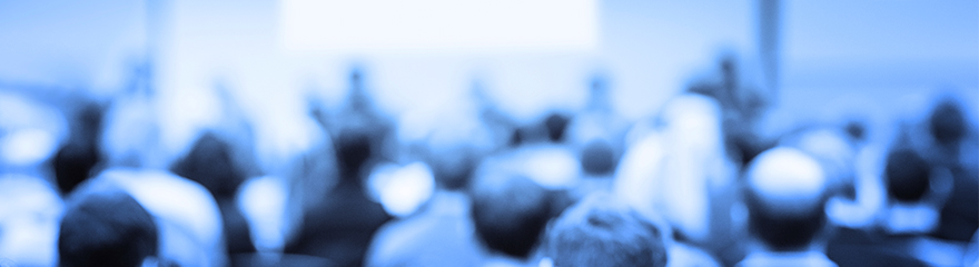 Blue image of a conference audience