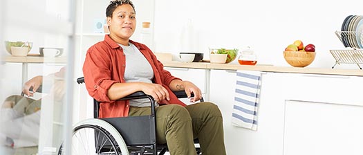 woman using wheelchair in kitchen