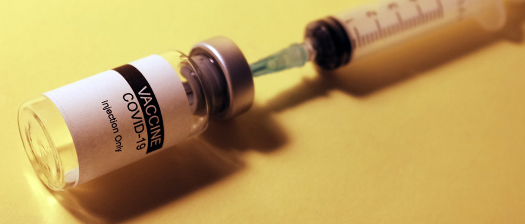 Image of a syringe and a vial of vaccine