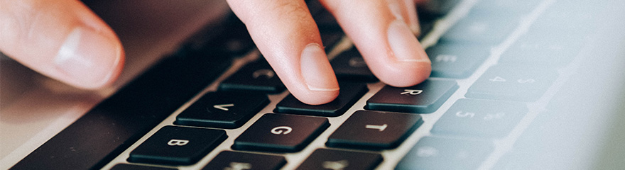 Close up of hands on laptop keyboard