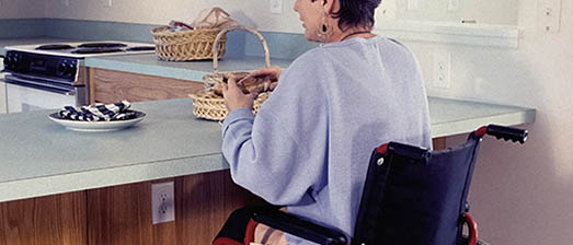person in wheelchair in kitchen