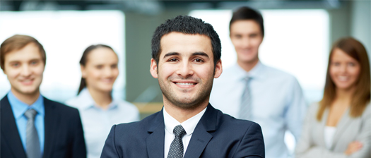 Image of group of people in business attire looking directly at camera