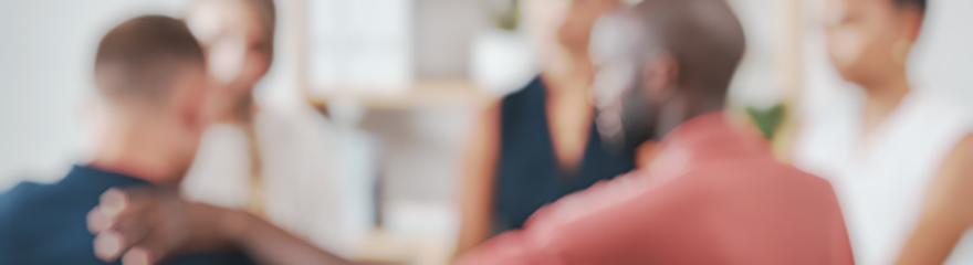 An out of focus image of a group of people sitting in a counselling session